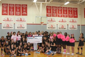 Sugar Land Middle School volleyball team, cheerleaders, and coaches present a check to FBJSL President-Elect Laura Taylor for the FBJSL Breast Cancer Fund.