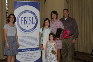 Left to Right: Dana Clement, 2015-2016 FBJSL President; Catherine Kubala, 2015-2016 Volunteer of the Year, and her family.